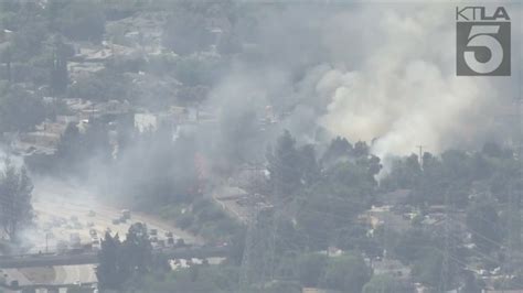 Portion of 118 Freeway closed as firefighters battle brush fire in Granada Hills